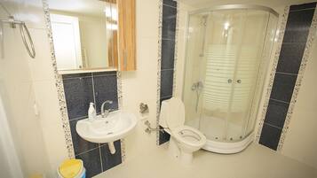 Shower, hair dryer, slippers, towels