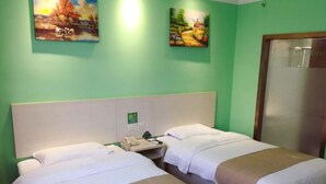 A hotel room with two beds, a nightstand, a phone, and a painting on the wall. - GreenTree Inn Shanghai Songjiang District Sijing Town Sijing Metro Station Express Hotel (Shanghai)