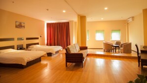 A hotel room with two beds, a sofa, a desk, and a chair. - GreenTree Inn DaLian Ganjingzi District Airport New District Lazishan Express Hotel (Dalian)