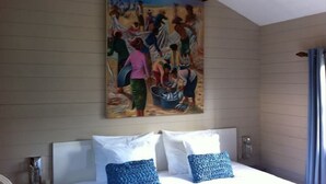 A bedroom with a bed, pillows, and a painting on the wall. - La Case Bois Creoles (the sea) (Albion)