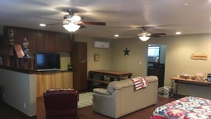 A compact living space with a kitchenette, a dining area, a sofa, and two beds. - Scriv's Haus (Winters)