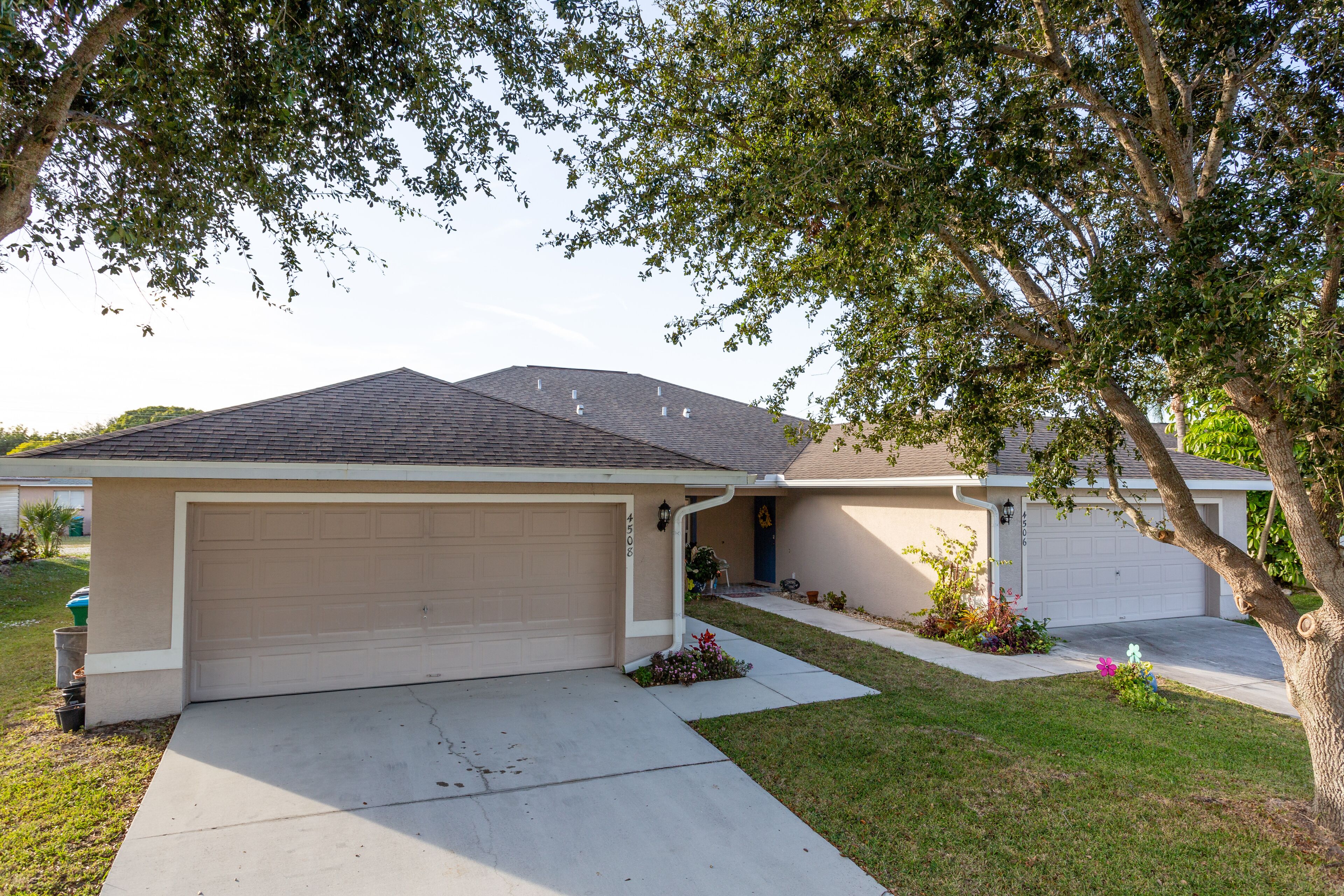 A residential house with a garage, a driveway, and a lawn.
