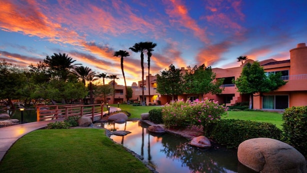 A resort with a swimming pool, palm trees, and a sunset view. - Westin Mission Hills (Rancho Mirage)