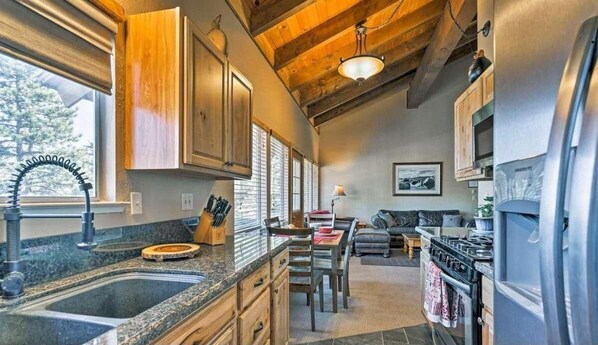 Enjoy cooking and dining in this well-equipped kitchen with a central island, gas stove, and ample storage.
