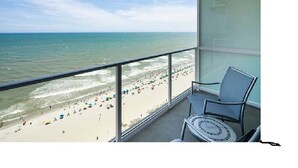 A balcony with a view of a beach and ocean. - ***PRICE DROPS, SPECIAL OFFER AUG 24/30*** Summer Get Away before School (Myrtle Beach)