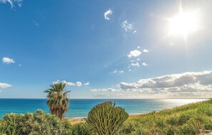 A coastal landscape with a clear sky, a palm tree, and a cactus in the foreground. - Awesome home in Menfi AG with WiFi (Menfi AG)