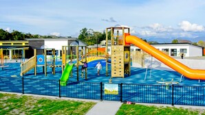 A water park with a large pool, slides, and play structures.