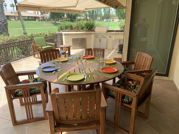 Built in BBQ on patio with teak furniture and electric awnings