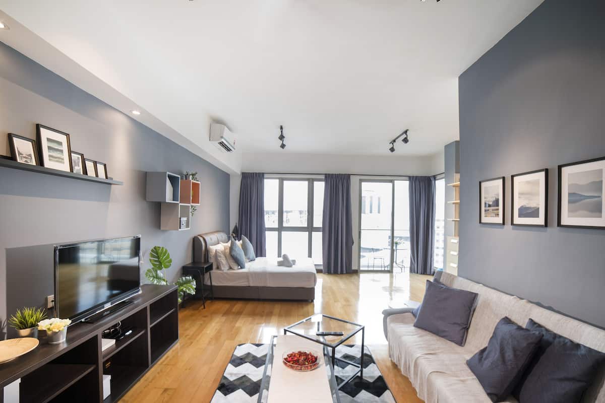 A modern living room with a flat-screen TV, sofa, and coffee table.