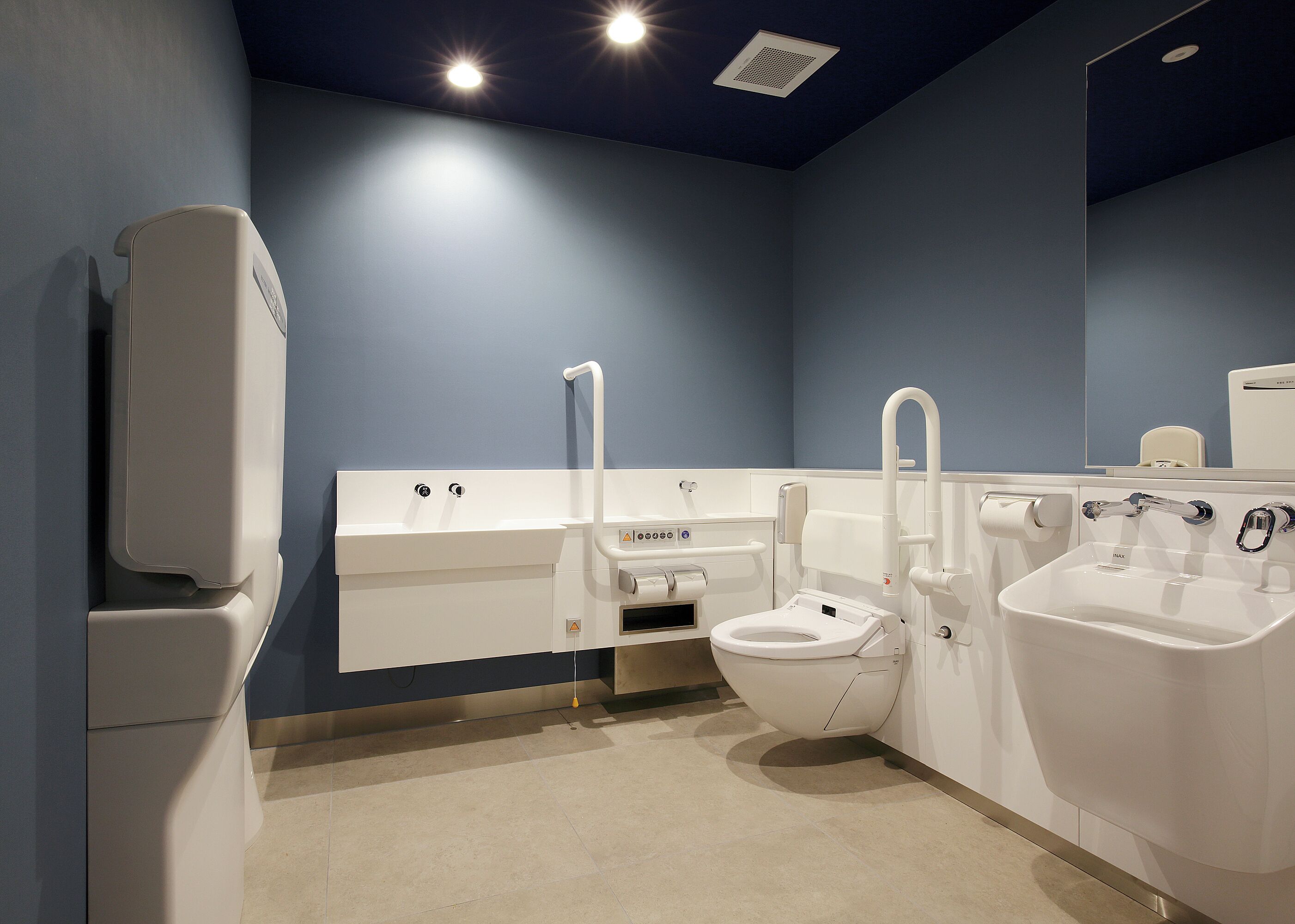 A modern bathroom with a toilet, bidet, and sink.