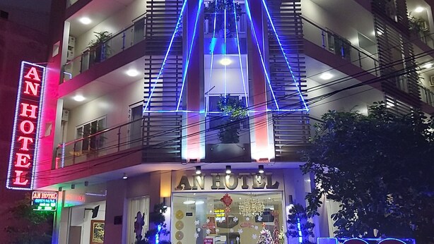 A multi-story hotel with a prominent neon sign reading "AN HOTEL" and a smaller sign below stating "AN HOTEL CAN THO". - An Hotel Can Tho (Can Tho)