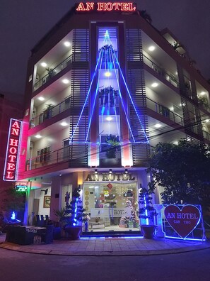 A multi-story hotel with a prominent neon sign reading "AN HOTEL" and a smaller sign below stating "AN HOTEL CAN THO". - An Hotel Can Tho (Can Tho)