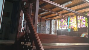 A traditional wooden structure with a slanted roof, a hanging rope, and patterned tiles. - duplex apartment on two floors with panoramic sea views (Le Moule)
