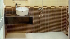 A bathroom with a sink, mirror, shower, and a wall-mounted heater. - Anh Duong Hotel (Hanoi)
