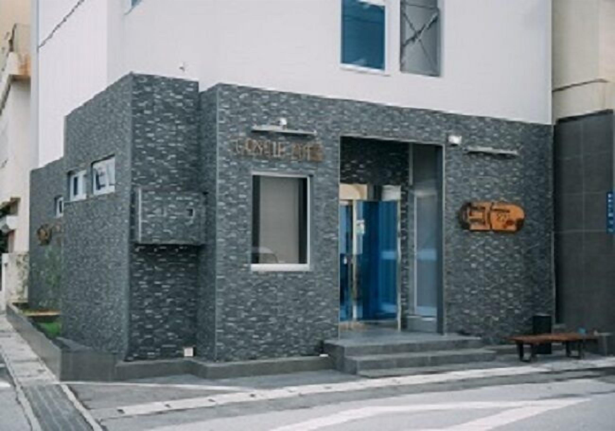A building with a stone facade and a blue door.