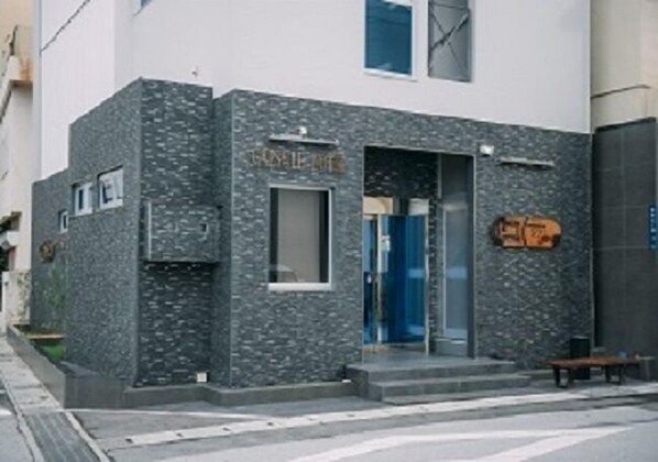A building with a stone facade and a blue door.