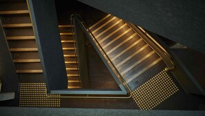 A modern staircase with a metal handrail and illuminated steps. - Premier Mill Hotel (Katanning)