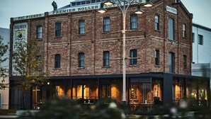 A brick building with signage for 'Premier Roller Flour' and 'F&C Piesse'. - Premier Mill Hotel (Katanning)