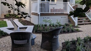 A house with a covered porch, outdoor seating, and a small garden. - Cherrywood - Luxury retreat - with complimentary EV charging (Exeter)