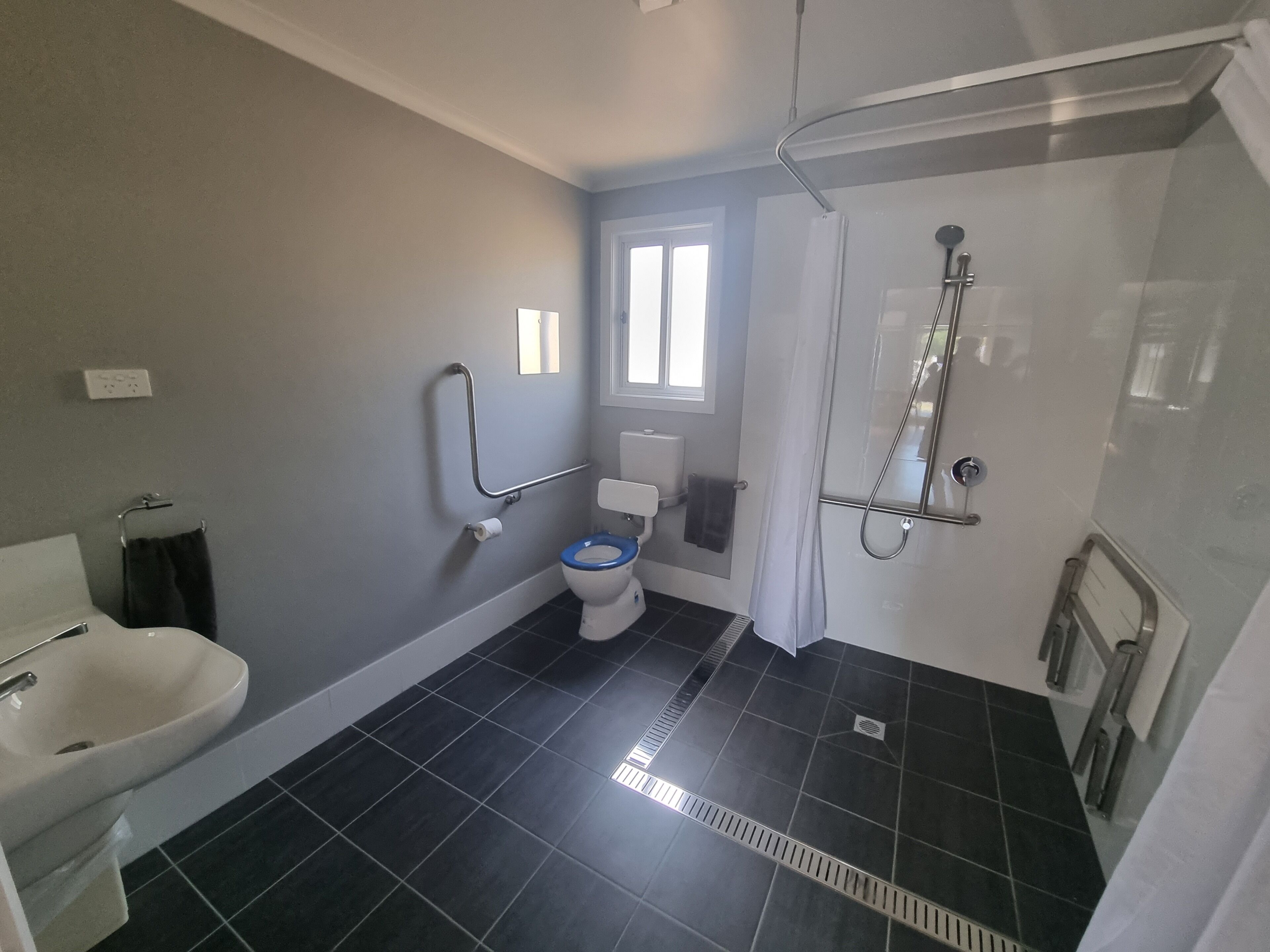 A bathroom with a toilet, bidet, and shower.