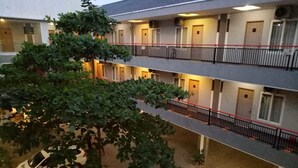 A multi-story hotel with balconies and a covered outdoor area. - Hotel Sonic Airport Semarang (Semarang)