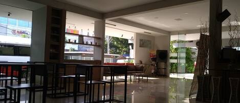 A spacious, modern interior with a bar area, seating, and a view of the outdoors.