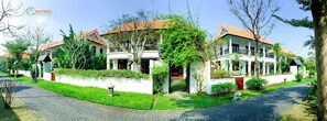 Experience the charm of traditional architecture at Quoc Trang Villa Resort, where a central entrance and beautifully maintained garden await.