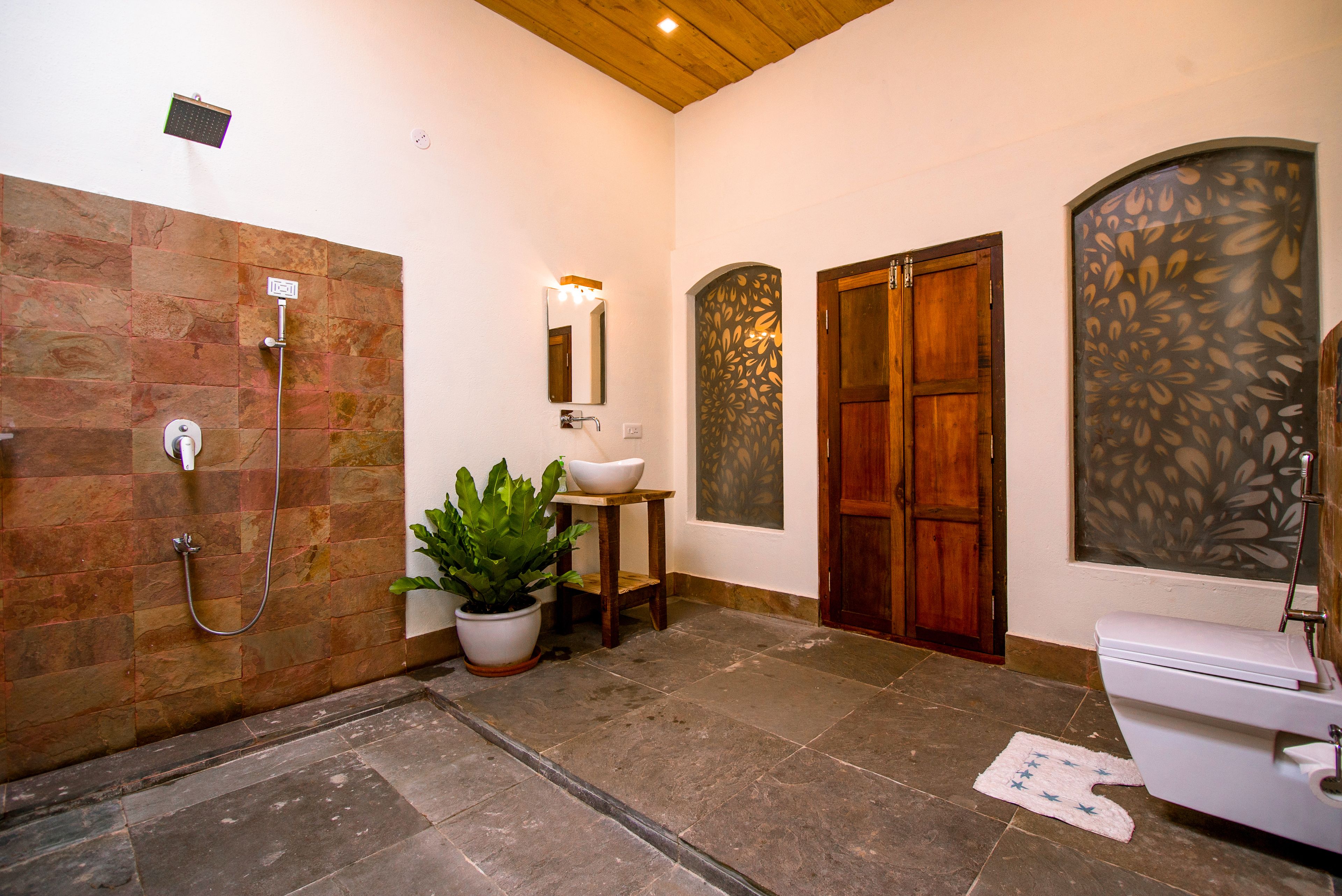 A bathroom with a shower, sink, and toilet.