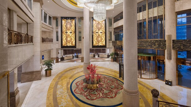A grand lobby with a central column, a chandelier, and a patterned floor. - Worldhotel Grand Jiaxing Hunan (Changsha)