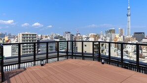 A cityscape with a prominent tower in the background. -  Henn na Hotel Premier Tokyo Asakusa Tawaramachi (Tokyo)