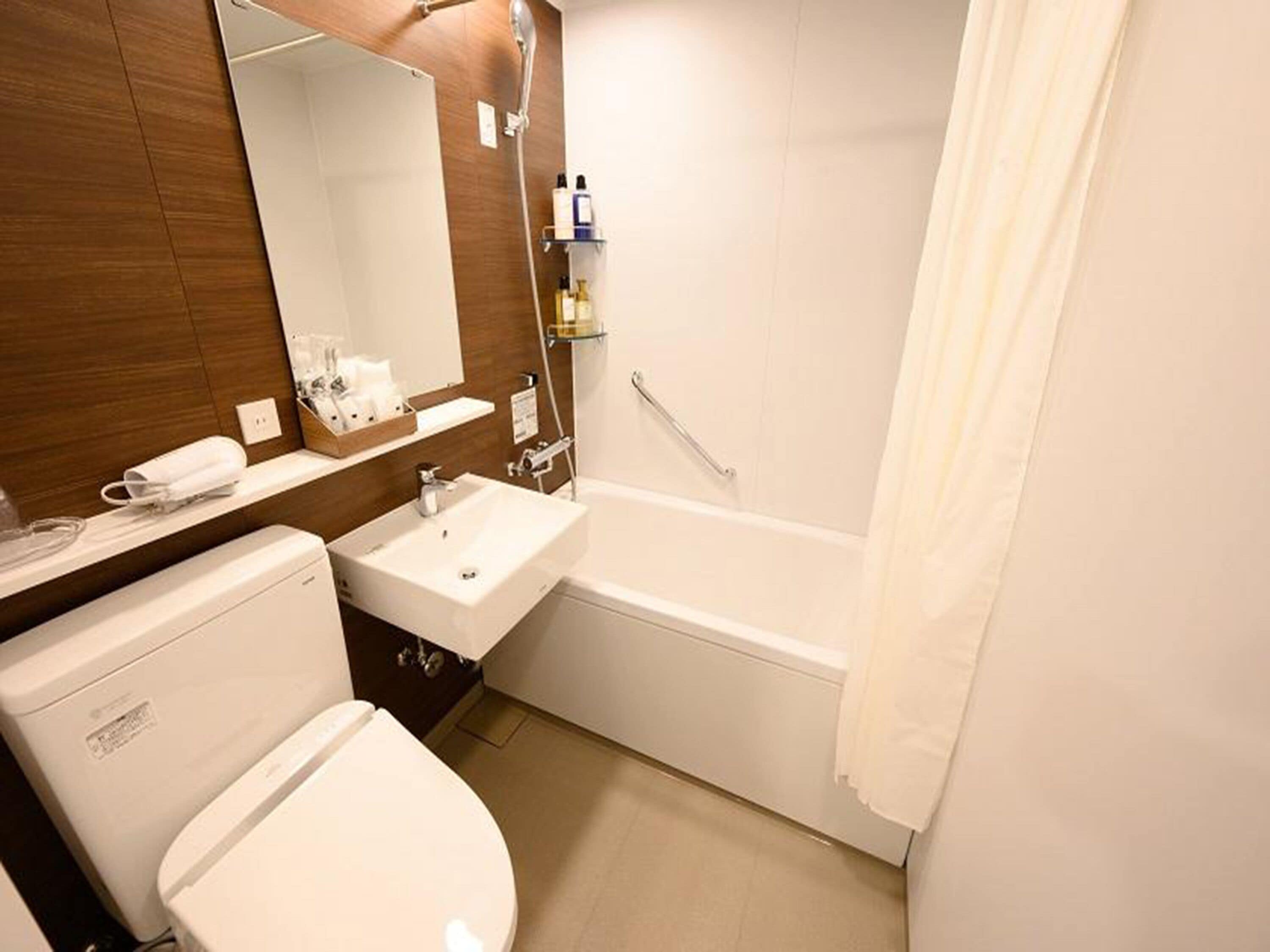 Een badkamer met toilet, wastafel en bad.