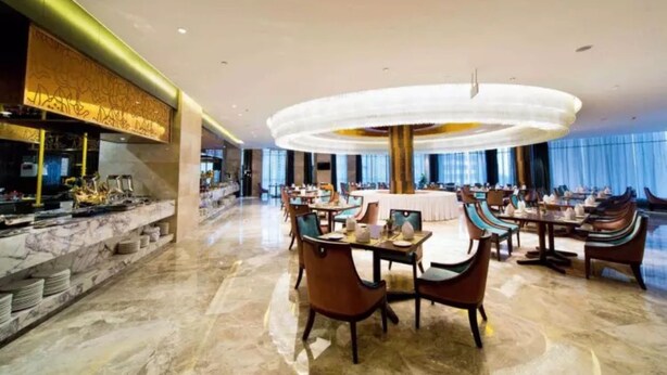 A spacious hotel lobby with marble flooring, a central round table, and multiple seating areas. - Changsha Jiaxing Inn (Changsha)