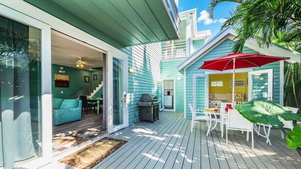 A spacious deck with a grill, outdoor seating, and a view of the house. - **SUMMER SOLSTICE @ OLD TOWN** 9BR Compound + Last Key White Glove Service... (Key West)
