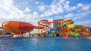 A water park with multiple slides and a pool. - Zina Beach Resort & SPA (Abdelmalek Ramdane)