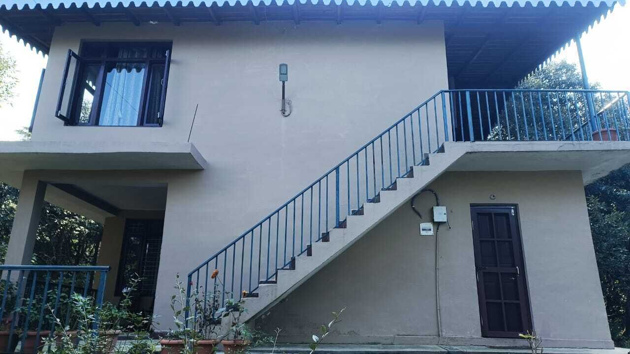 A two-story building with a staircase leading to a balcony.