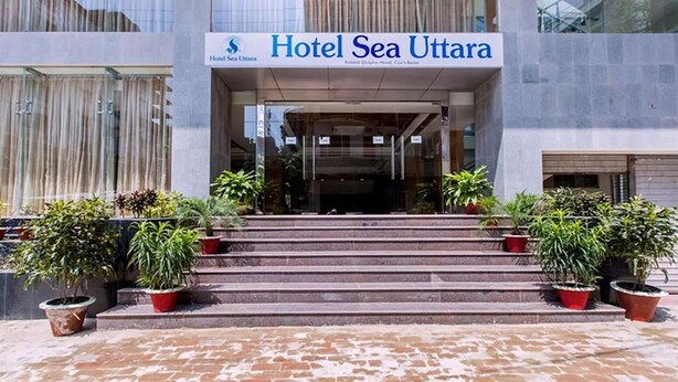 The entrance of Hotel Sea Uttara with a sign above the entrance and steps leading up to it.