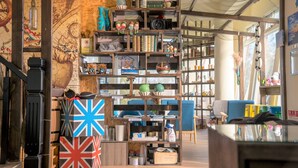 A room with a wooden wall, a map, shelves with various items, and a blue chair. - Starrysky Family (Magong)