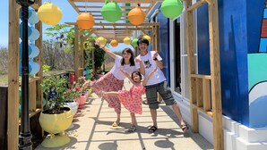 A wooden pergola with colorful hanging planters and potted plants. - Starrysky Family (Magong)