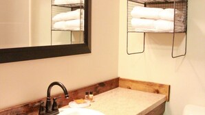 A bathroom with a sink, mirror, and towel racks. - Crosby Lodge (Crosby)
