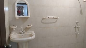 Basic Double Room, 1 Queen Bed | Bathroom | Shower, rainfall showerhead, free toiletries, slippers