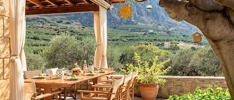 An outdoor dining area with a view of a mountainous landscape.