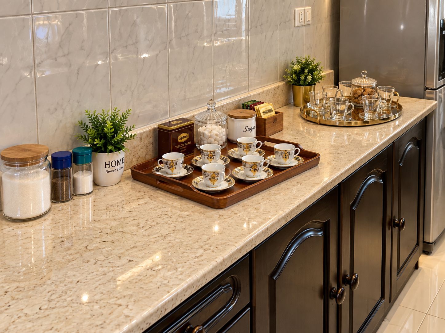 A kitchen counter with a tray of teacups, sugar, and Lipton tea boxes.