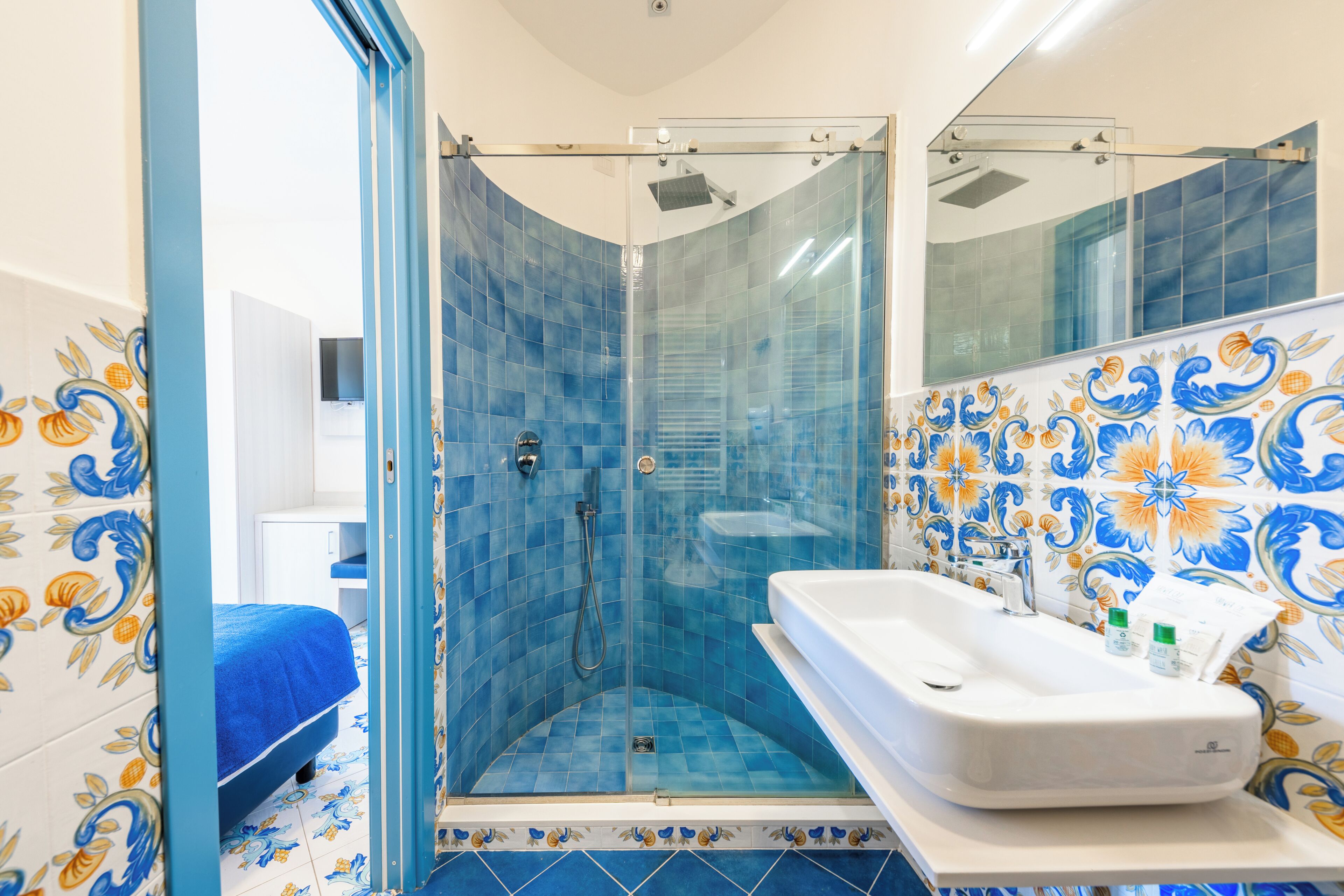 A bathroom with a shower, a bathtub, and a sink.