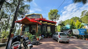 A building with a sign reading "Hotel Bliss." - Hotel Bliss (Kasauli)