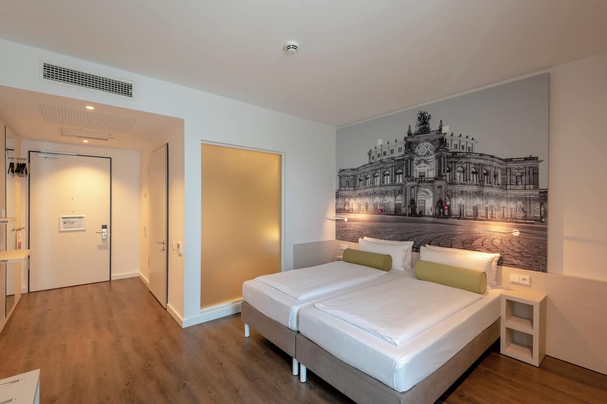 Ropa de cama hipoalergénica y caja de seguridad en la habitación