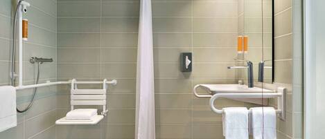 A modern bathroom with a shower, a toilet, and a sink.