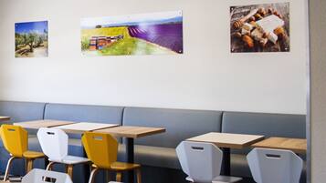 A restaurant interior with booths, tables, and chairs.