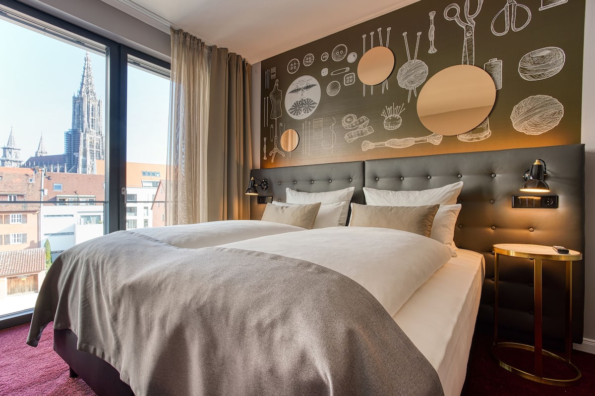 boutique quadruple room | in-room safe, desk, laptop workspace, blackout curtains