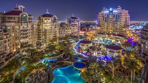 A resort with multiple buildings, a central pool area, and surrounding greenery. - Roda Al Murooj Residences (Dubai)