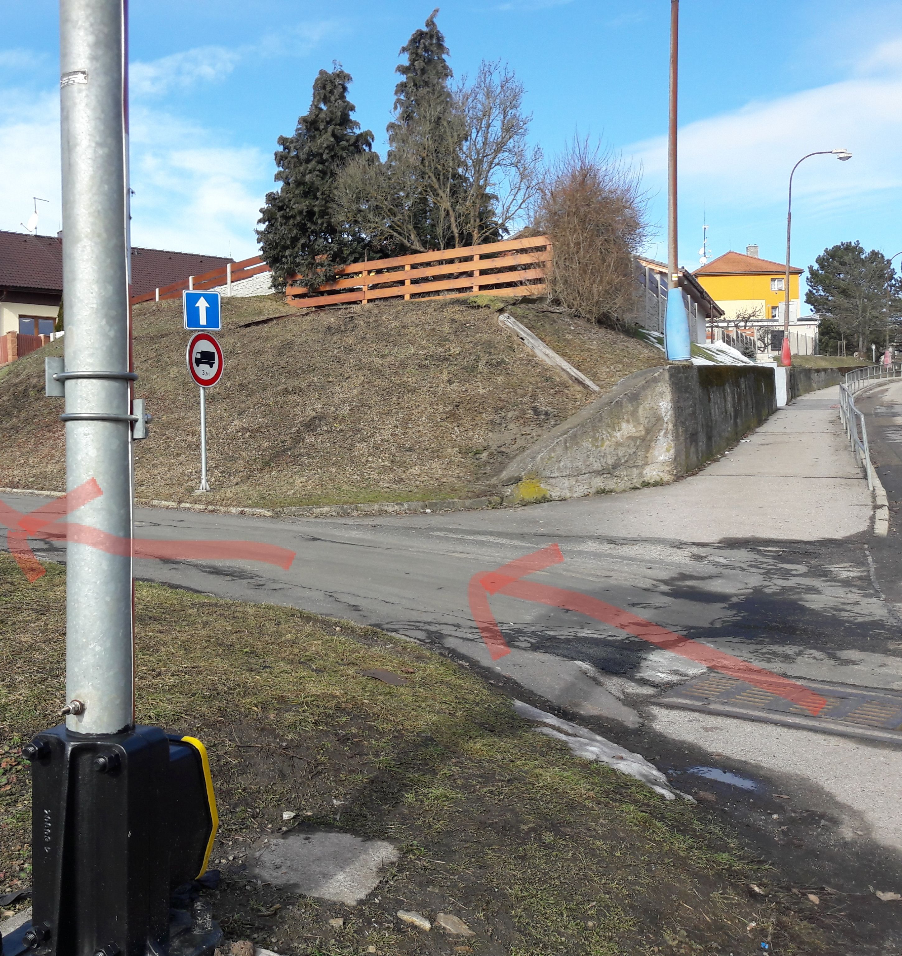 A road with directional arrows and a no-truck sign.